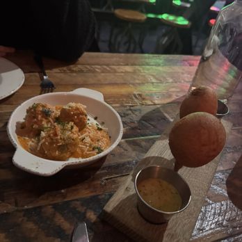 Butcher and the Brewer signature dishes Black Truffle Meatball, Baked Brie, Taphouse Tacos.